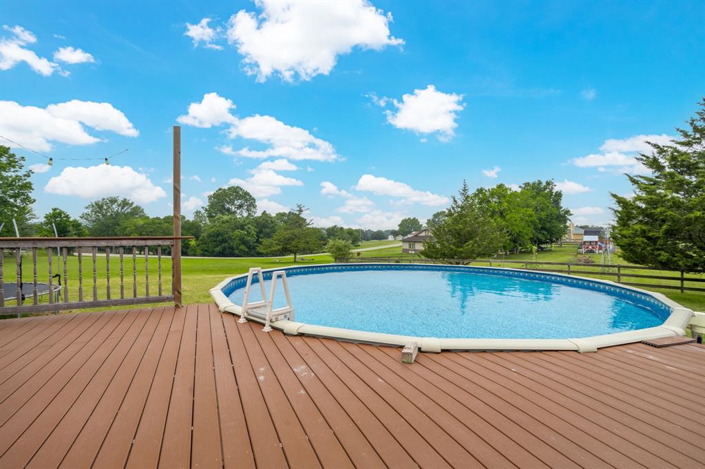 Above ground pool and wood deck.