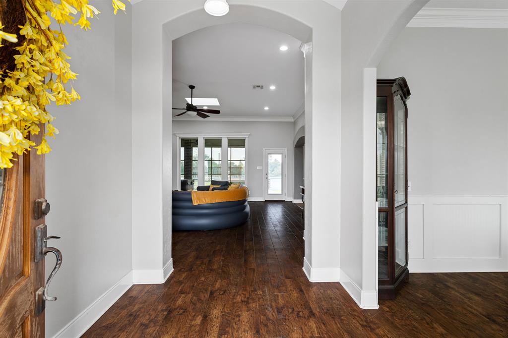 Vinyl wood like flooring in living, dining, & study/office room.  Beautiful arch entry ways and tall baseboards.