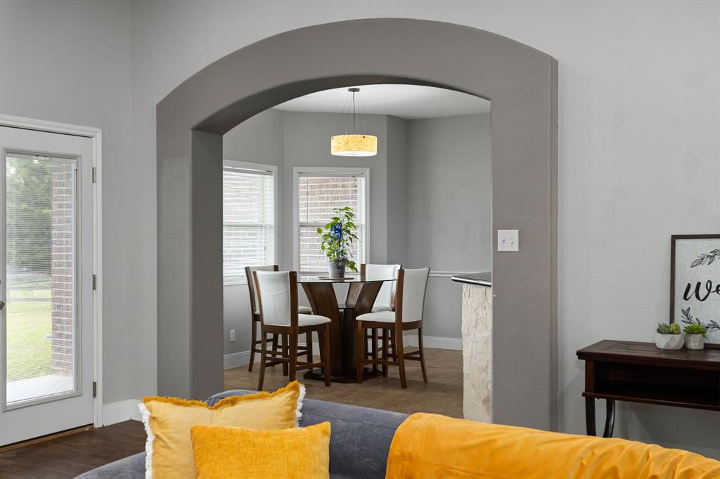 Archway from living room to breakfast nook and kitchen bar.