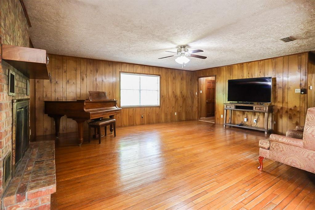 View from kitchen and living area with brick wood burning fireplace.