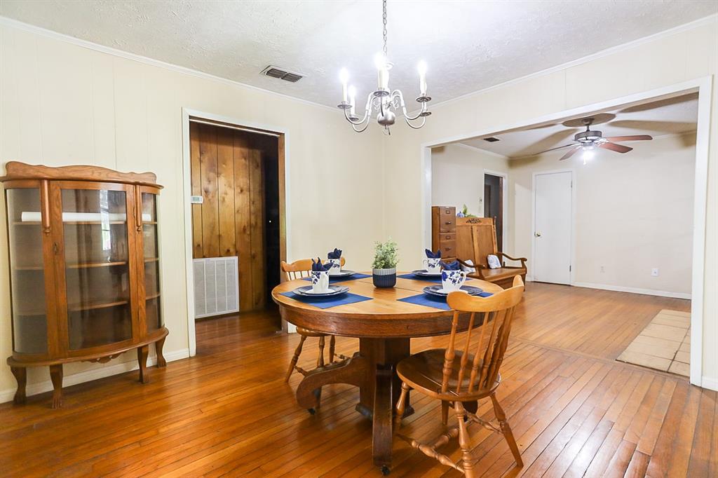 Dining room open to formal living with wood floors.