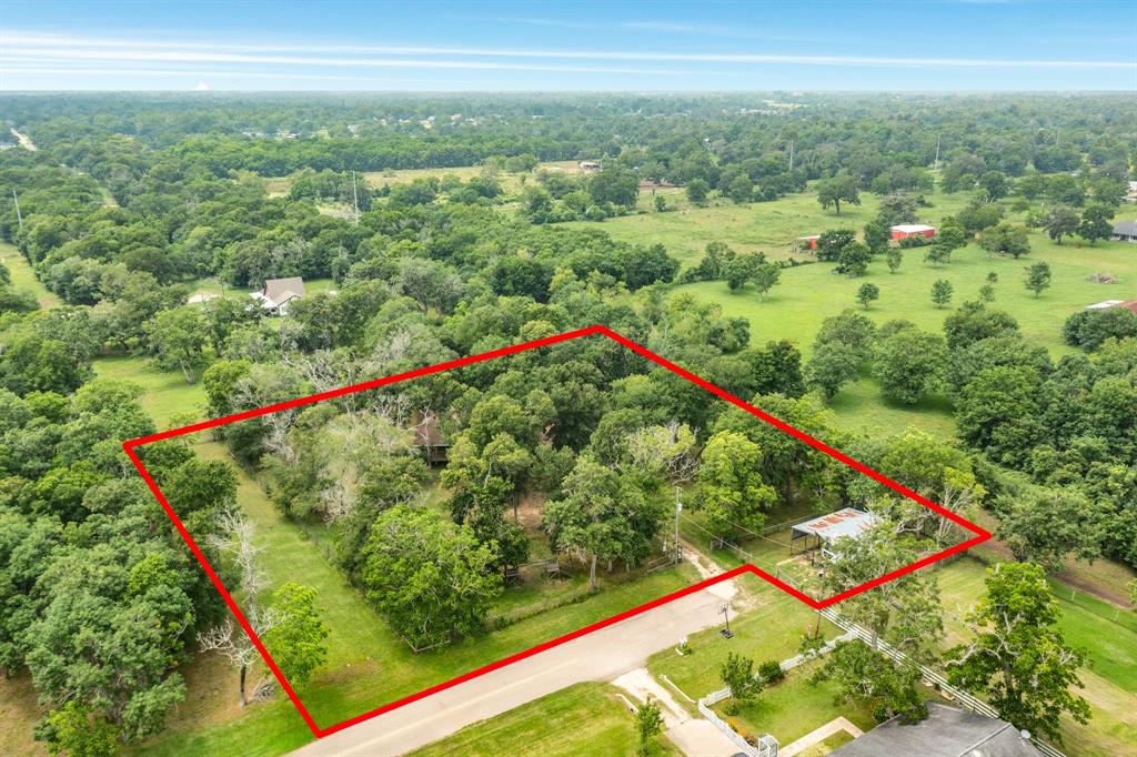 Spanning 1.6 acres, mostly fenced with a gate at the entrance of the driveway.