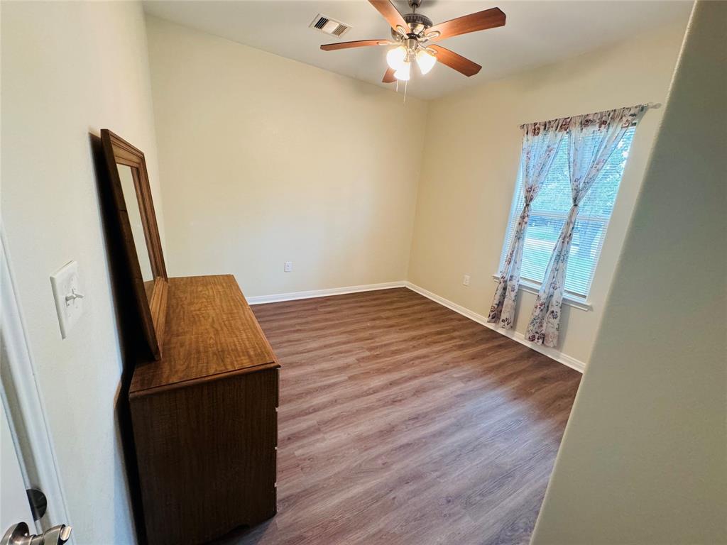 Front Guest bedroom of generous size, great lighting, and plenty of closet space.