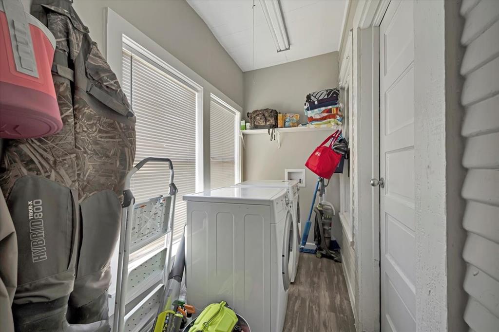 Laundry room inside house with windows viewing the backyard