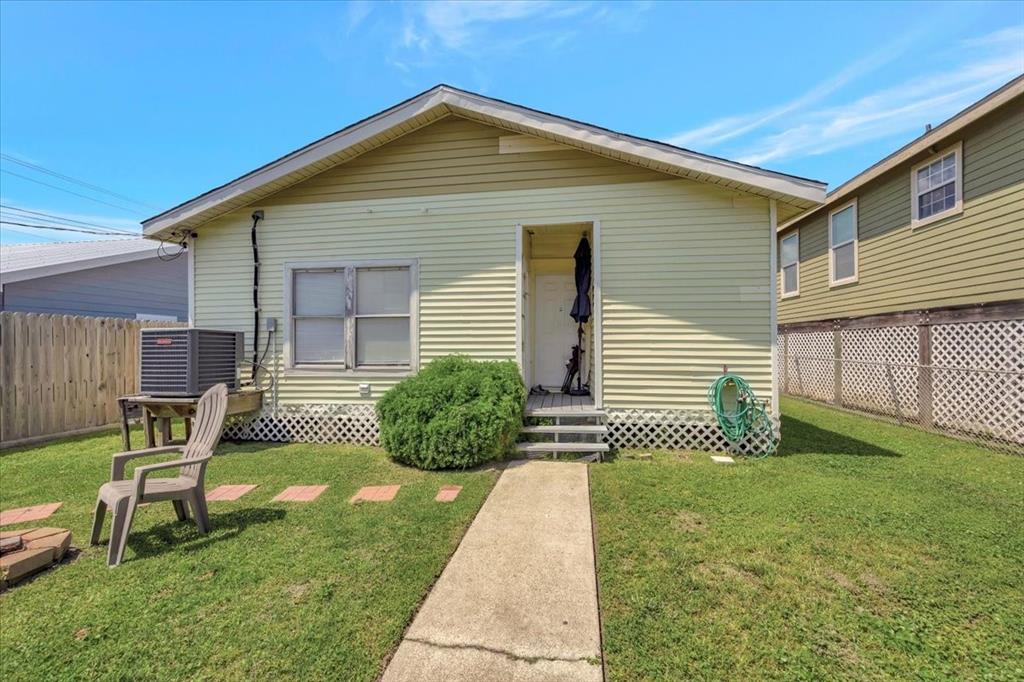 Back of house. Windows on left lead to the laundry room