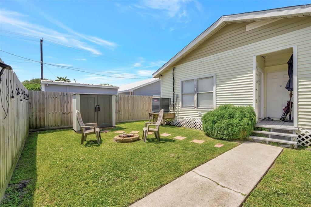 Rear entrance to home . Walk leads to the garage. Shed is not included as it is tenants, but don\'t worry there\'s plenty of space in the three car garage