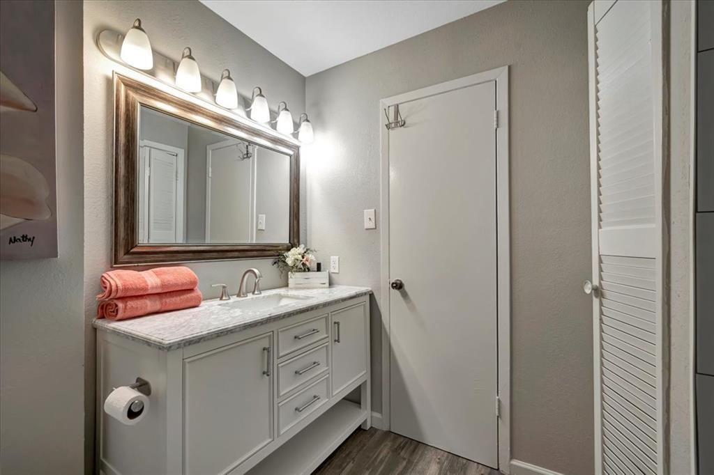 Beautiful vanity with granite countertop includes drawers, covered storage and open storage below