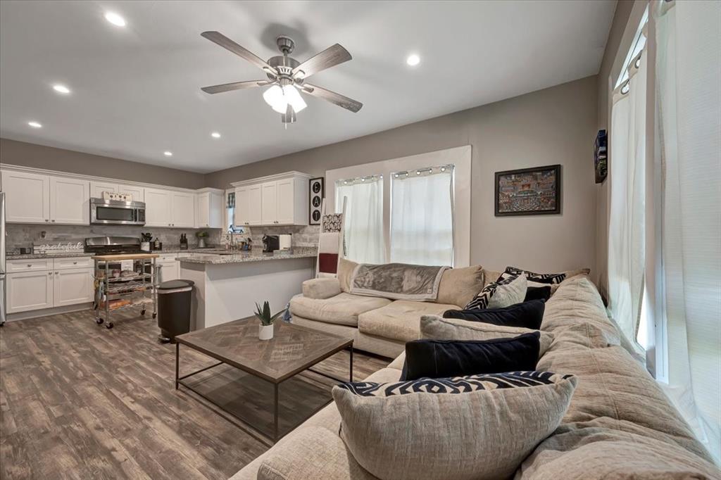 Such a spacious layout integrating the kitchen and den. Couches are included in the sale.