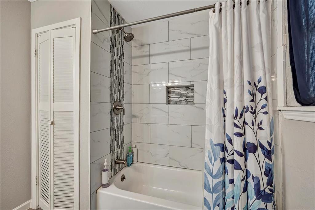 Linen closet, shampoo holder with mosaic tile and check out the ceramic tile in the tub shower surround.