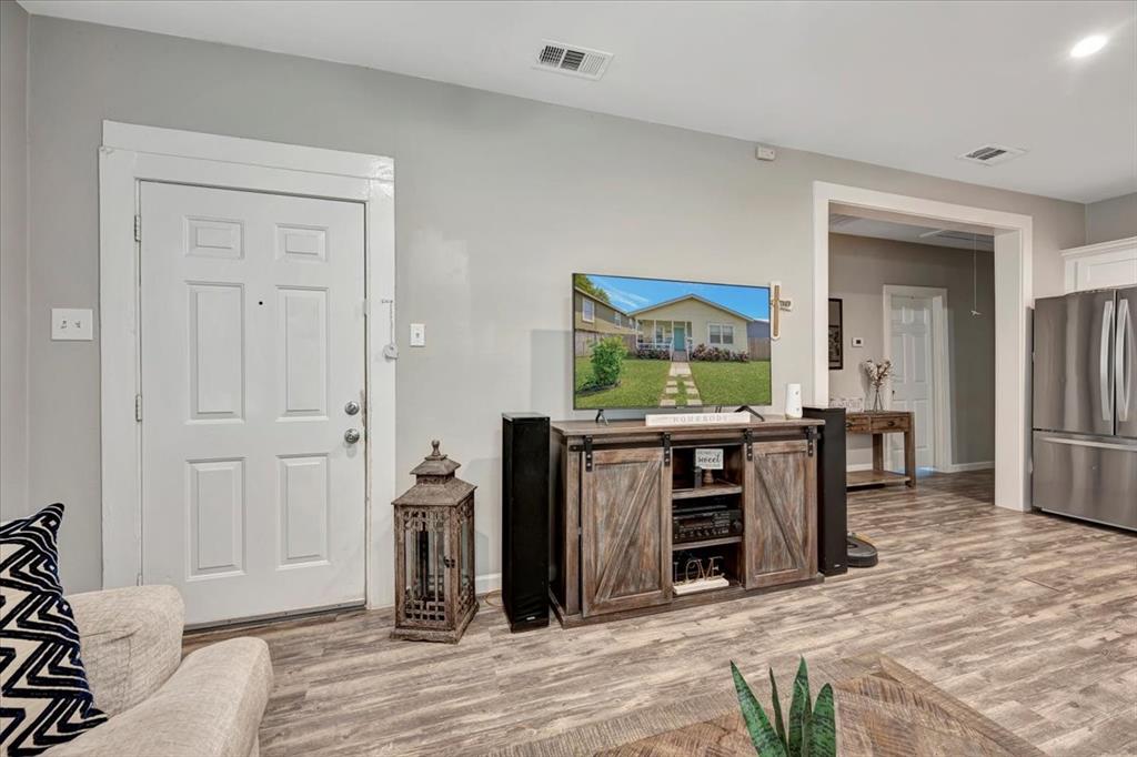 Left door is another entrance to the porch and front yard. Hallway on right leads to the 3 bedrooms