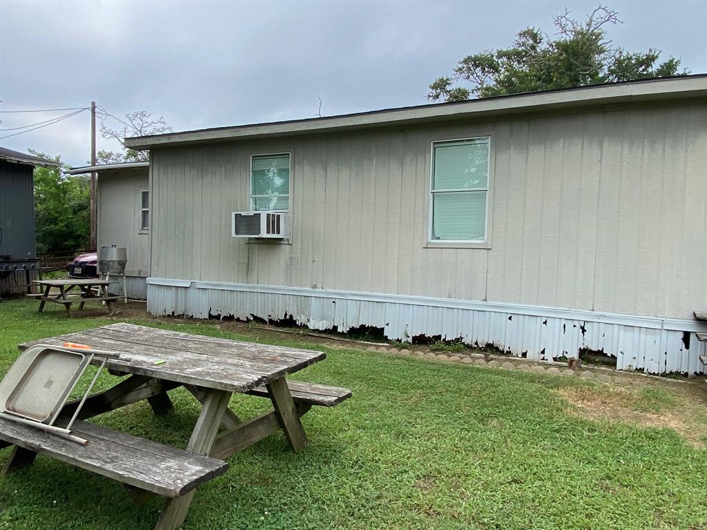 Left side of home in back & picnic table