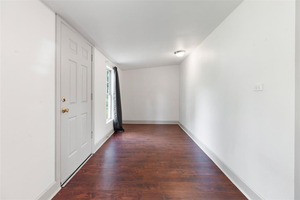 Rear room of home. This would make a great office space, playroom or room for your pets.