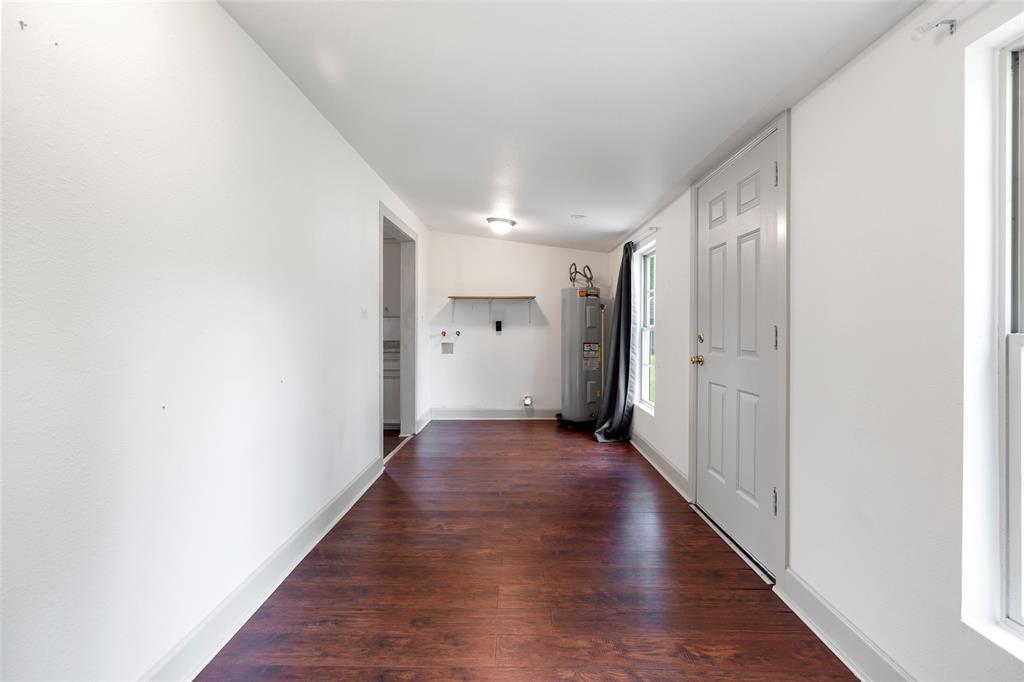 Utility room, ample storage & back door leading to back yard.