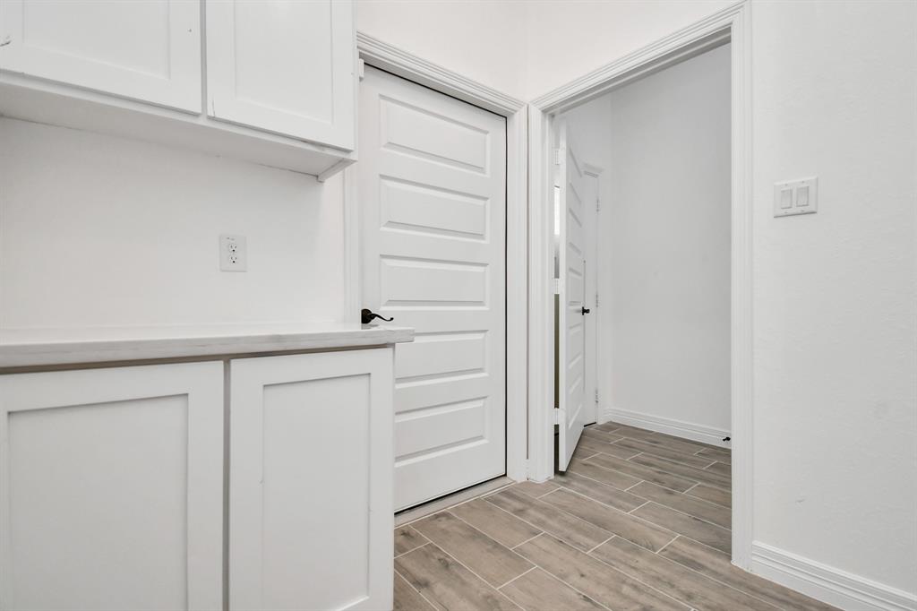 Utility room, Door opening to garage with extra cabinets and counter space