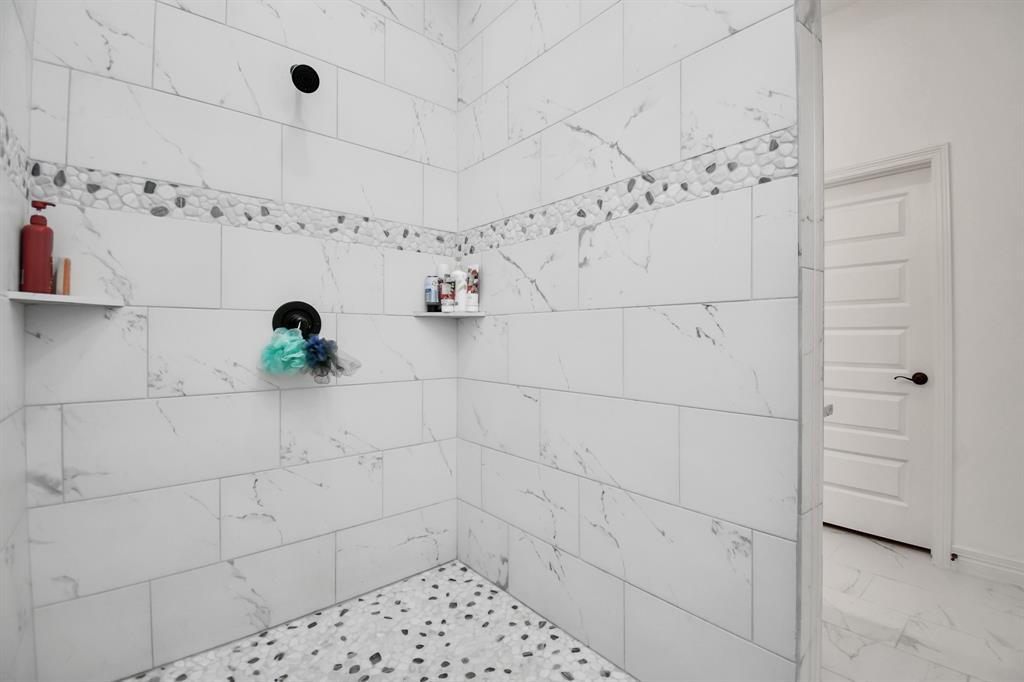 Open shower area of primary bathroom