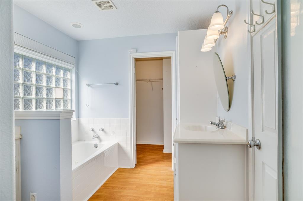 Primary bath boasting of natural light with privacy glass blocks.