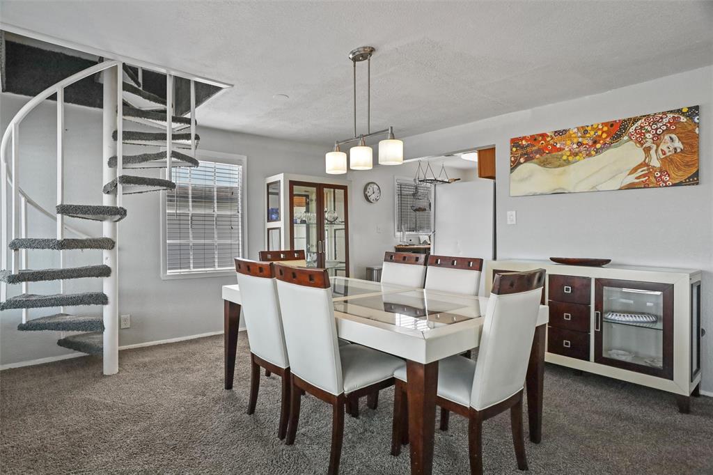 The Dining room/Living room combo has an Open Concept, with kitchen in the rear, and spiral staircase leading to the Primary Bedroom. There is an additional Bedroom downstairs.