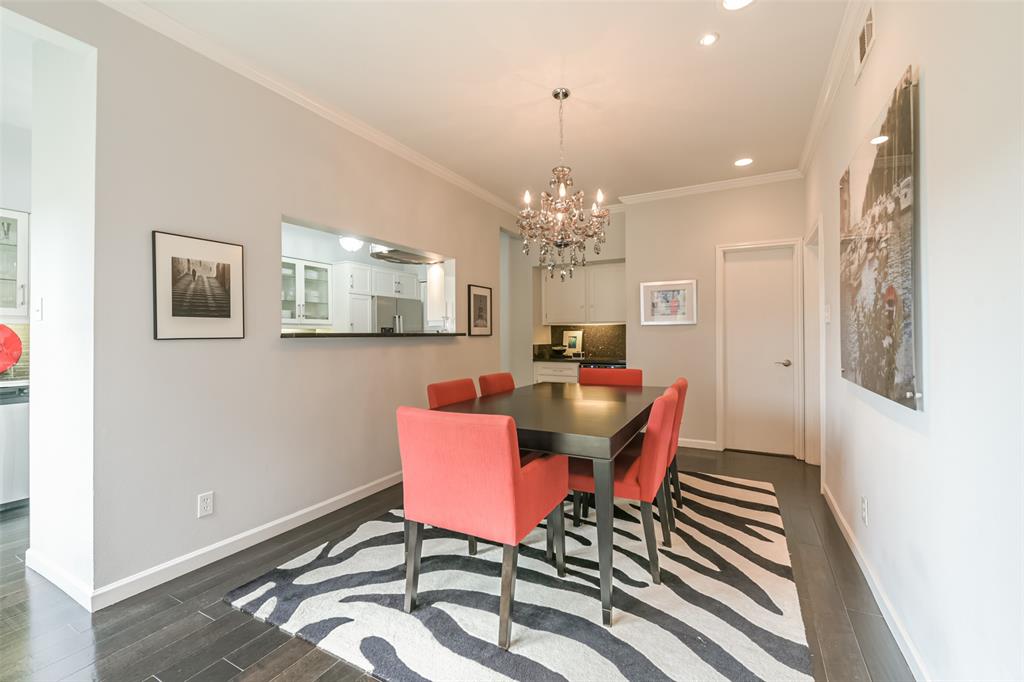 Another view of the dining room showcases access to outdoor living spaces.  The wet bar is conveniently tucked away near the door.