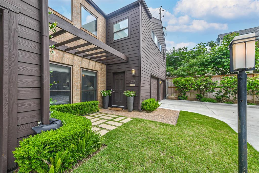 Immaculate landscaping and a charming front patio invite you to step inside.