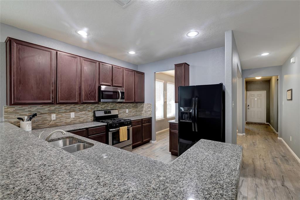 View of all that granite and breakfast bar.