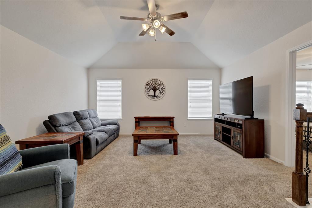 At the top of the stairs is the game room with ceiling an, new carpet and architecturally pleasing ceiling design.