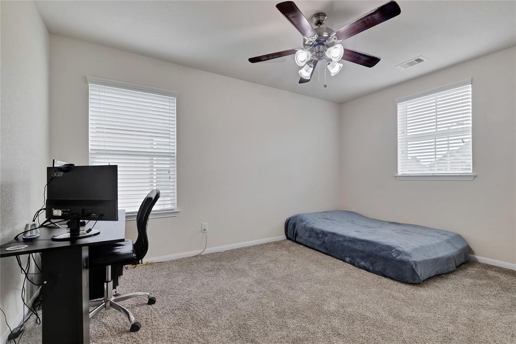 This bedroom has two windows and ew carpet