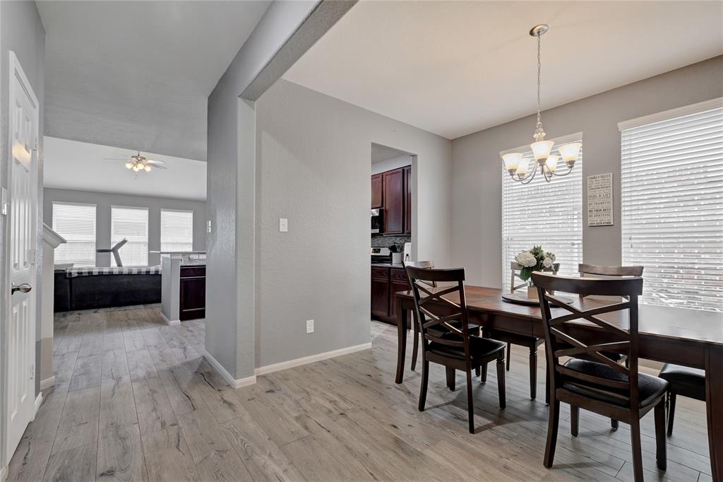 Hallway view of open formal dining room leading to kitchen and living room.