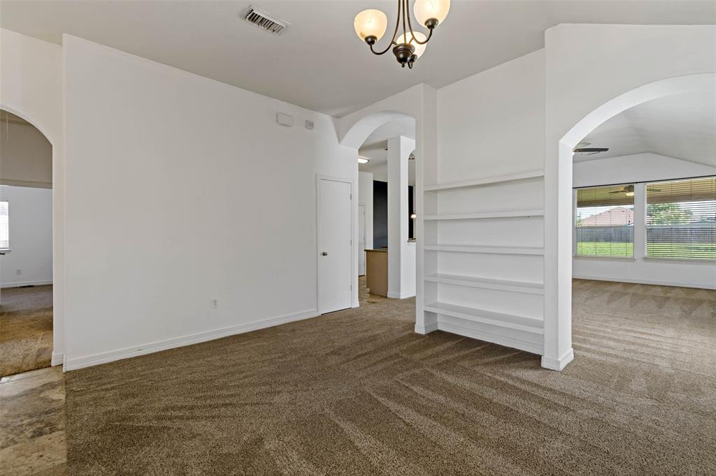 Built in bookcase has multiple uses, whether this room is a study, playroom or additional living space