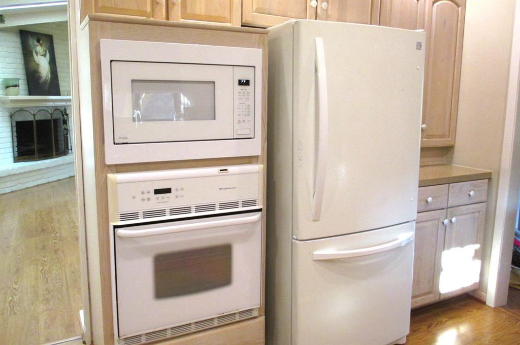 Recent microwave, electric oven and additional storage to the right