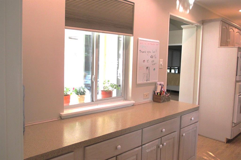 Additional countertop and cabinet space next to breakfast area