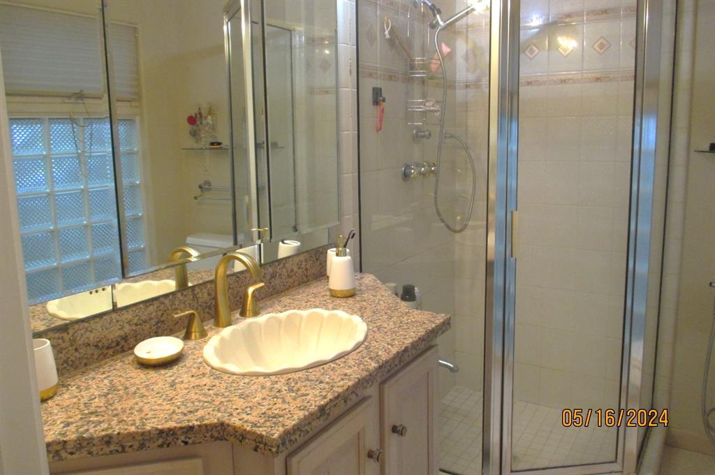 Primary shower with granite counter/sink