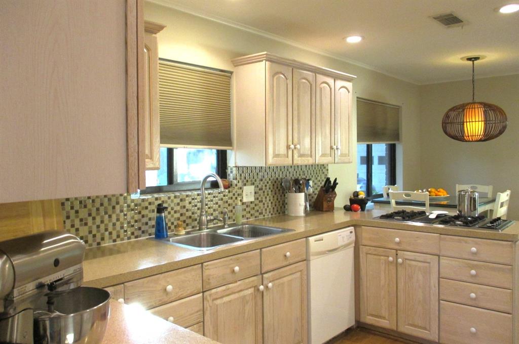 Loads of recessed lighting, countertop and cabinet space with gas stove top