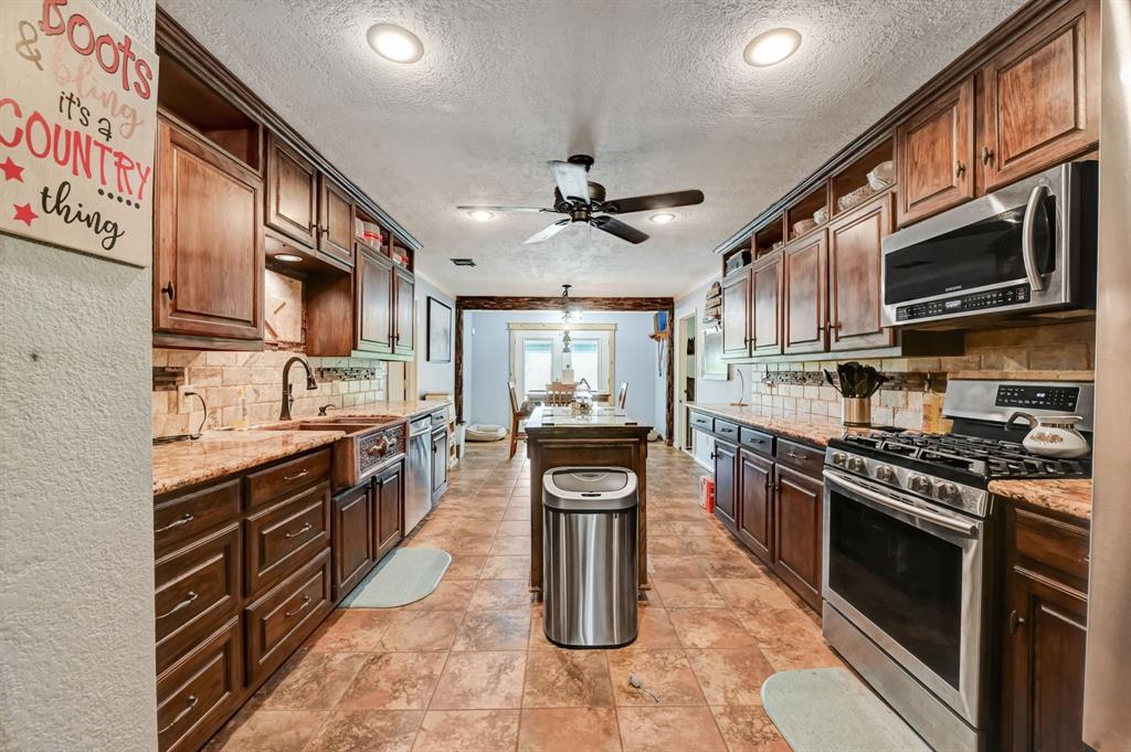 Kitchen opens to the dining room and leads to both bedrooms and back yard.