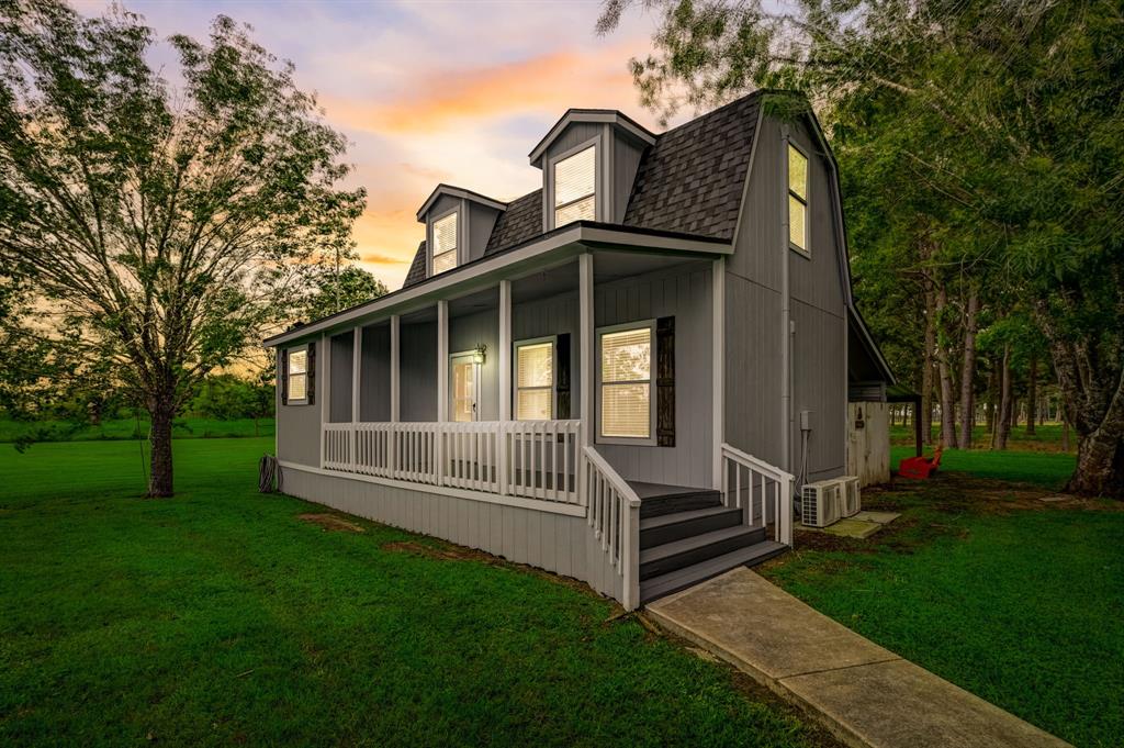 Detached guest house includes expansive front porch. New roof, mini splits and paint.