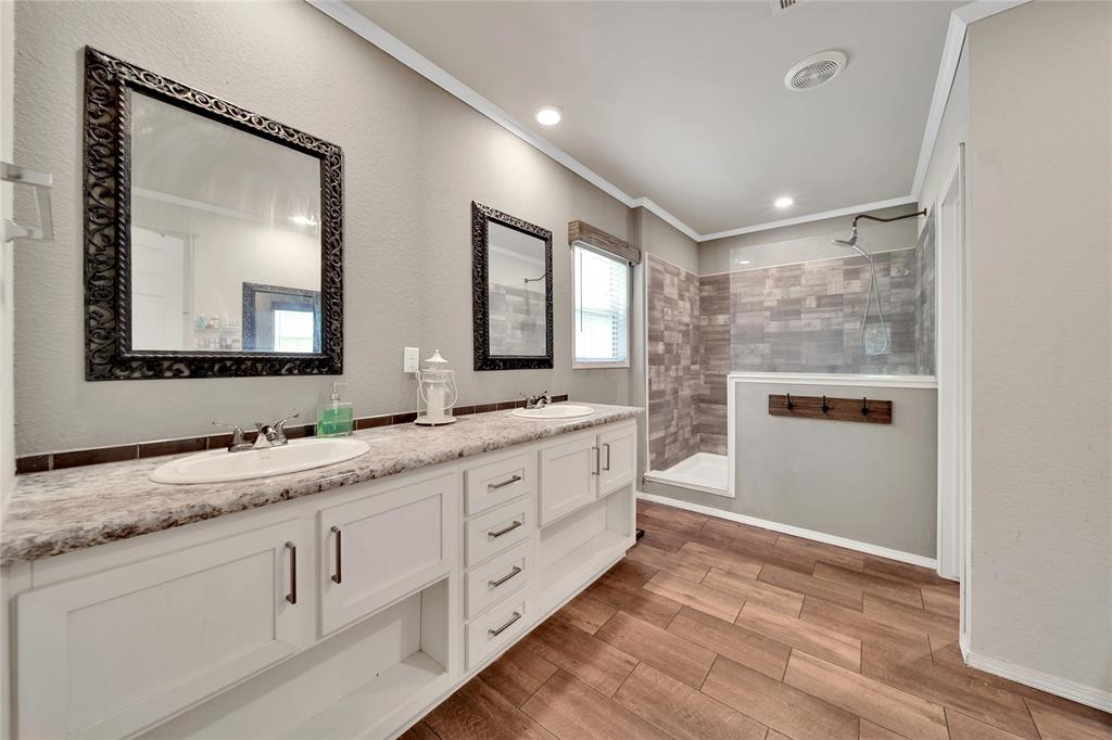 Primary bathroom offers double sinks, large shower, vanity, and built in cabinetry!