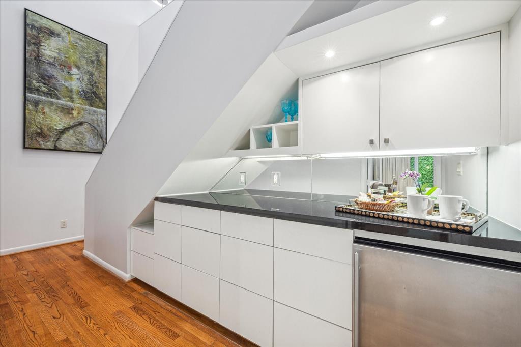 A breakfast bar and fridge are just outside the Primary and Secondary Bedrooms.