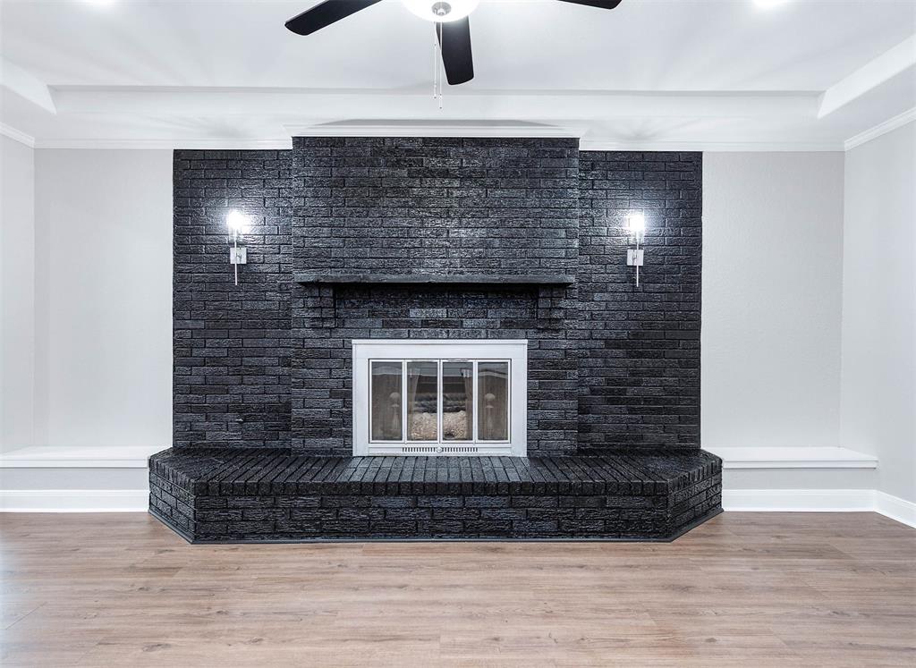 This black brick accented fireplace with the scones lighting is a BEAUTIFUL accent piece.