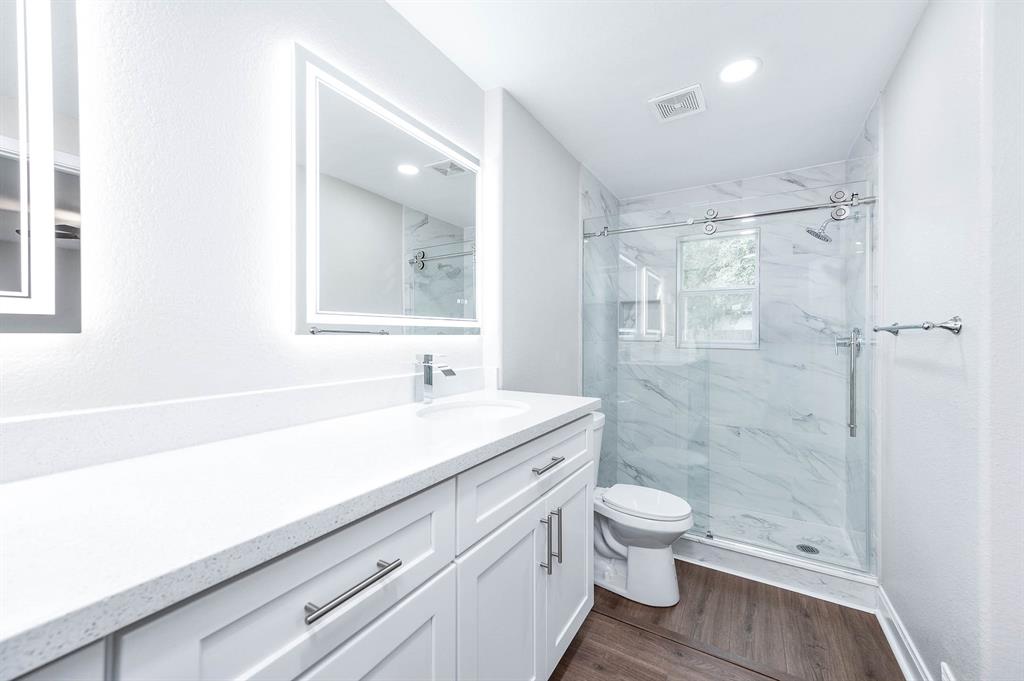 Master bathroom with plenty of counter space and tile accented shower.