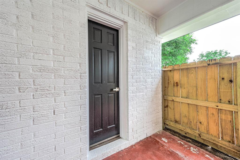 This side door in the breezeway is to the half bath in the garage.