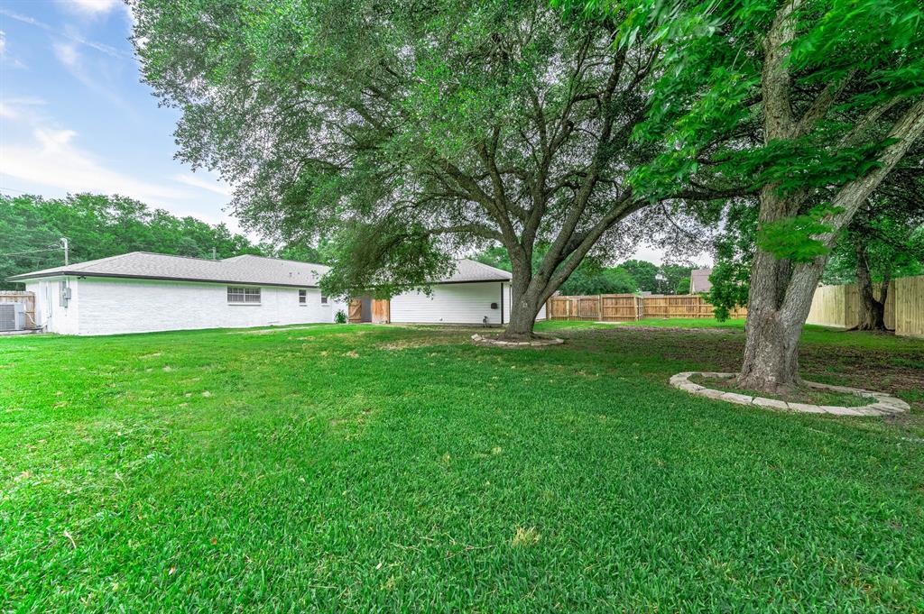 HUGE SHADE TREES ACCENT THIS LARGE FULLY FENCED BACKYARD !!