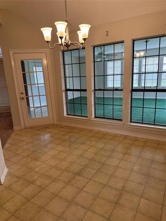 Breakfast area with wall of windows looking into the sunroom add on