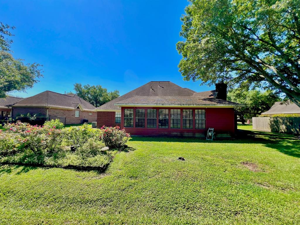 view of back of the home - this is the sunroom located at the back of the house