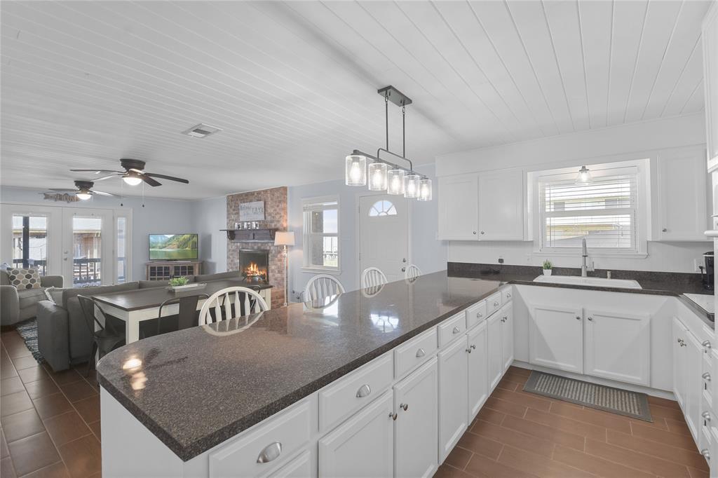 Lots of cabinets for storage.  Notice the beautiful wood lined ceiling and updated light fixture