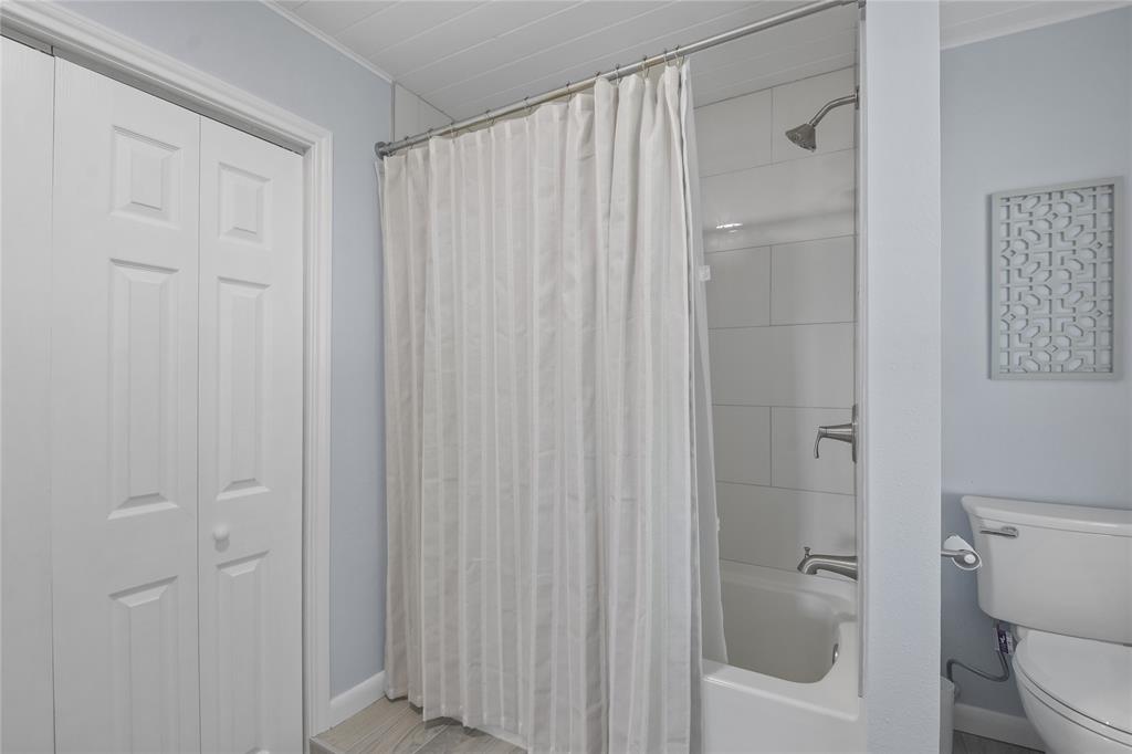 Beautiful tile work surrounds the primary tub/shower