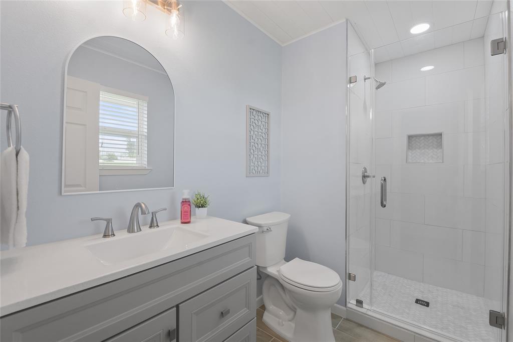 Stunning freshly remodeled guest bathroom with tiled walk in shower and large vanity