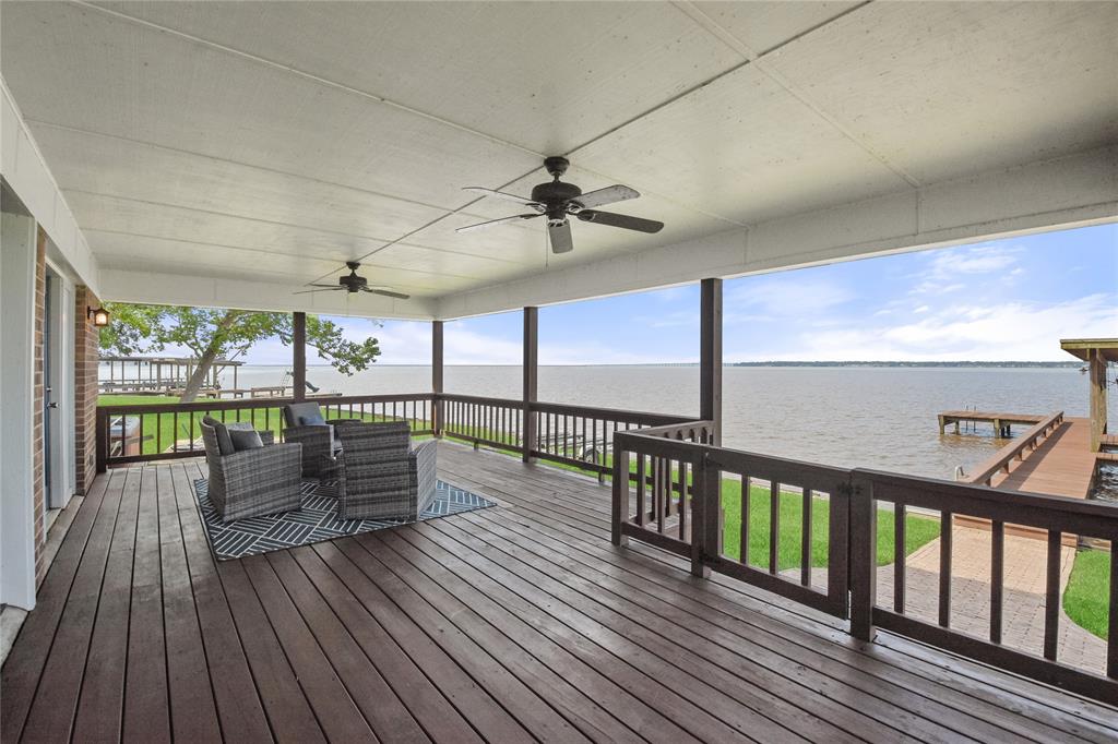 Your favorite spot at the lake will undoubtedly be sitting out on this huge covered back porch where you can take in all of the lakefront activities