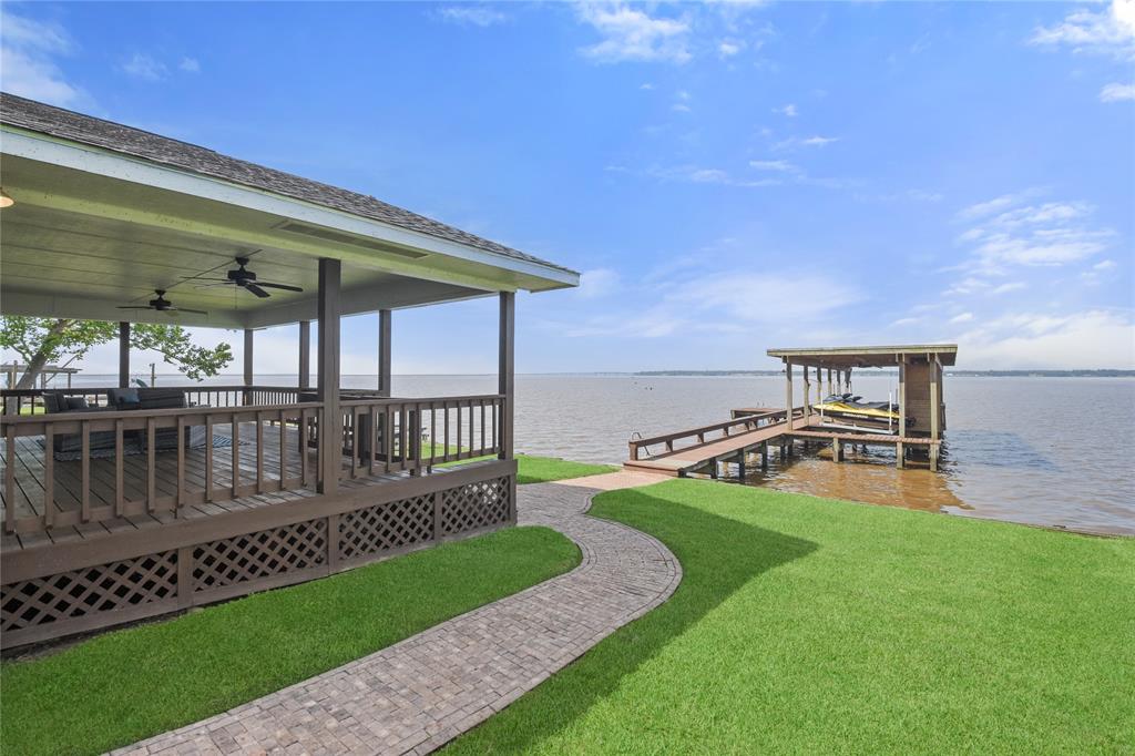 pave stone lined walkway leads from carport to the back porch and on to the boat dock