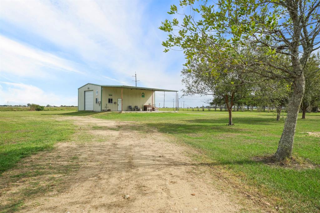 Separate driveway to the additional 1 acre lot with warehouse