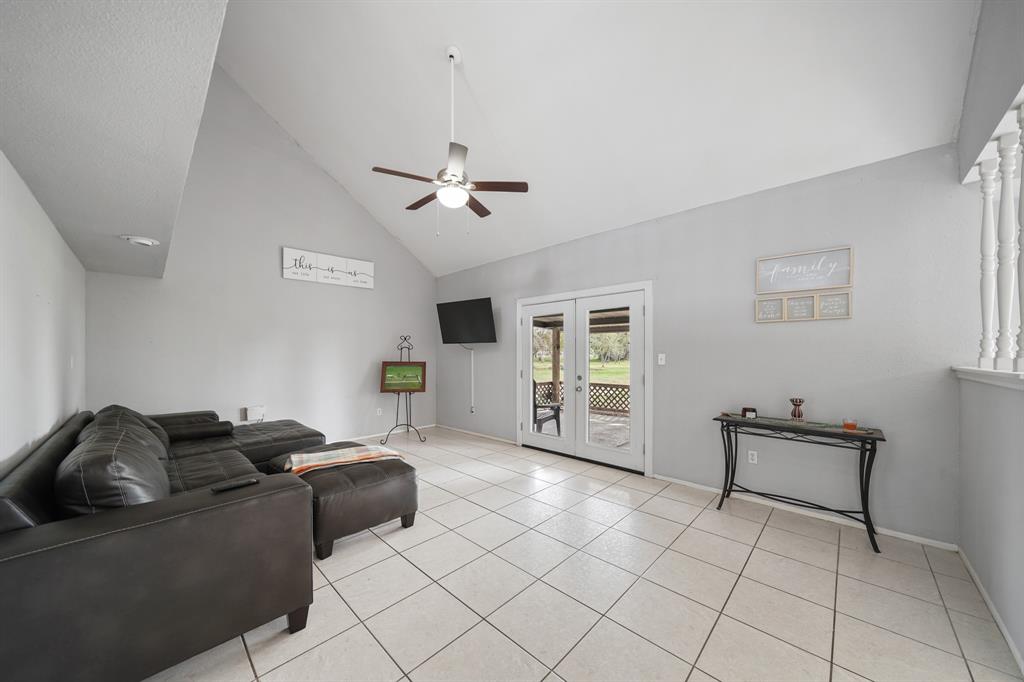 Vaulted ceiling living room with french doors to the covered patio