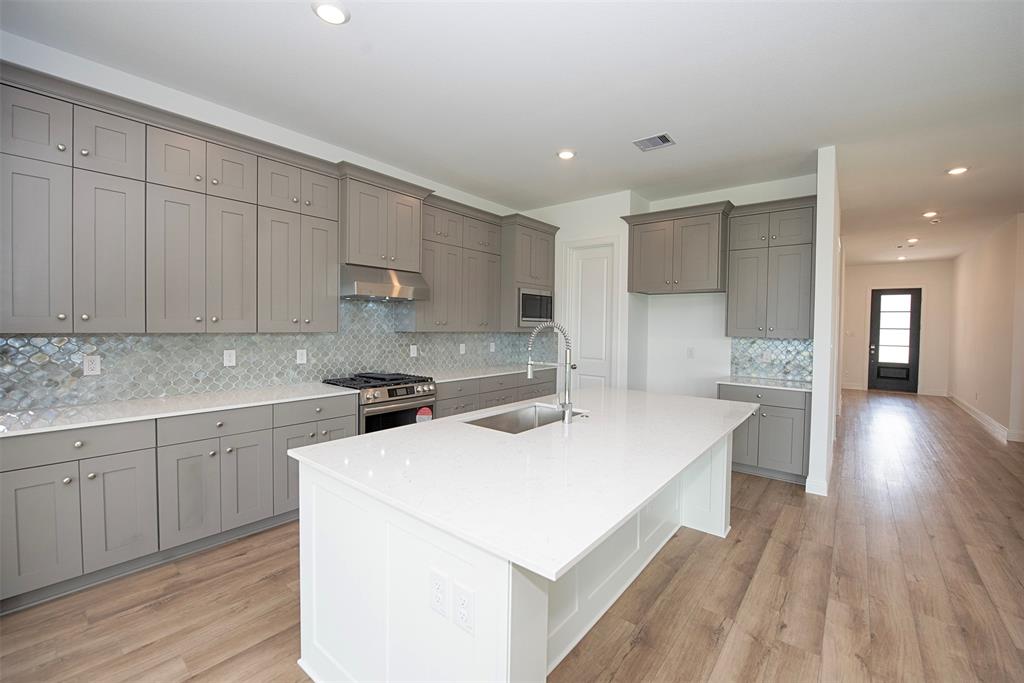 Another view of the kitchen showing the amazing storage with shaker style cabinetry. The breakfast bar is the perfect spot for your morning coffee or meals on the go. It\'s perfect for the kids having breakfast in the morning.